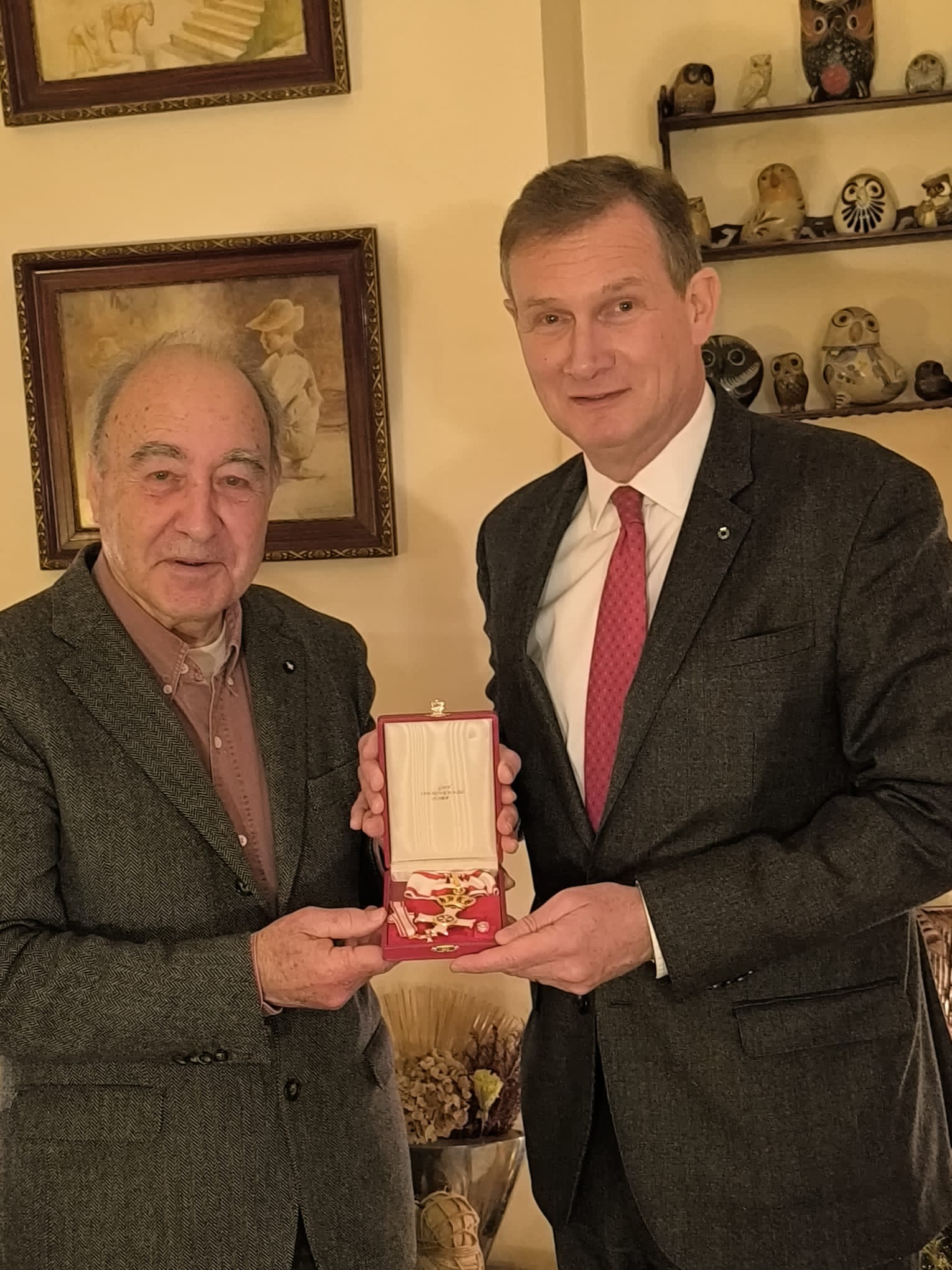 HE Ambassador Yves Gazzo, presents the honorary ensigns Pro Merito Melitensi